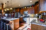 Kitchen and breakfast bar with granite counter tops.